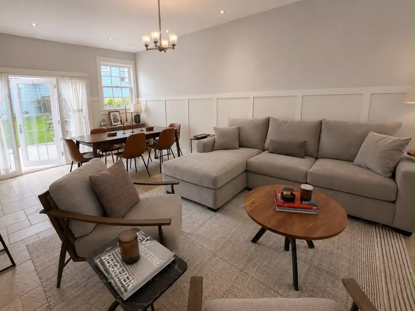 The great room opens through French doors to the backyard